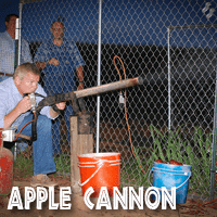 Image of a visitor to Jaemor Farms shooting an apple out of an air compression cannon