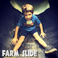 Image of a little boy at the bottom of the Jaemor Farms farm slide