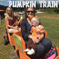 Two mothers with their children riding on the Jaemor Farms pumpkin train