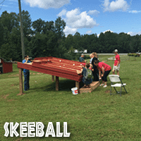 A group of people enjoying the skeeball area of Jaemor Farms